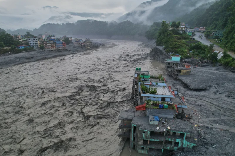 Nepal flood rescue crews clearing debris near a damaged hydropower tunnel after deadly Himalayan flooding